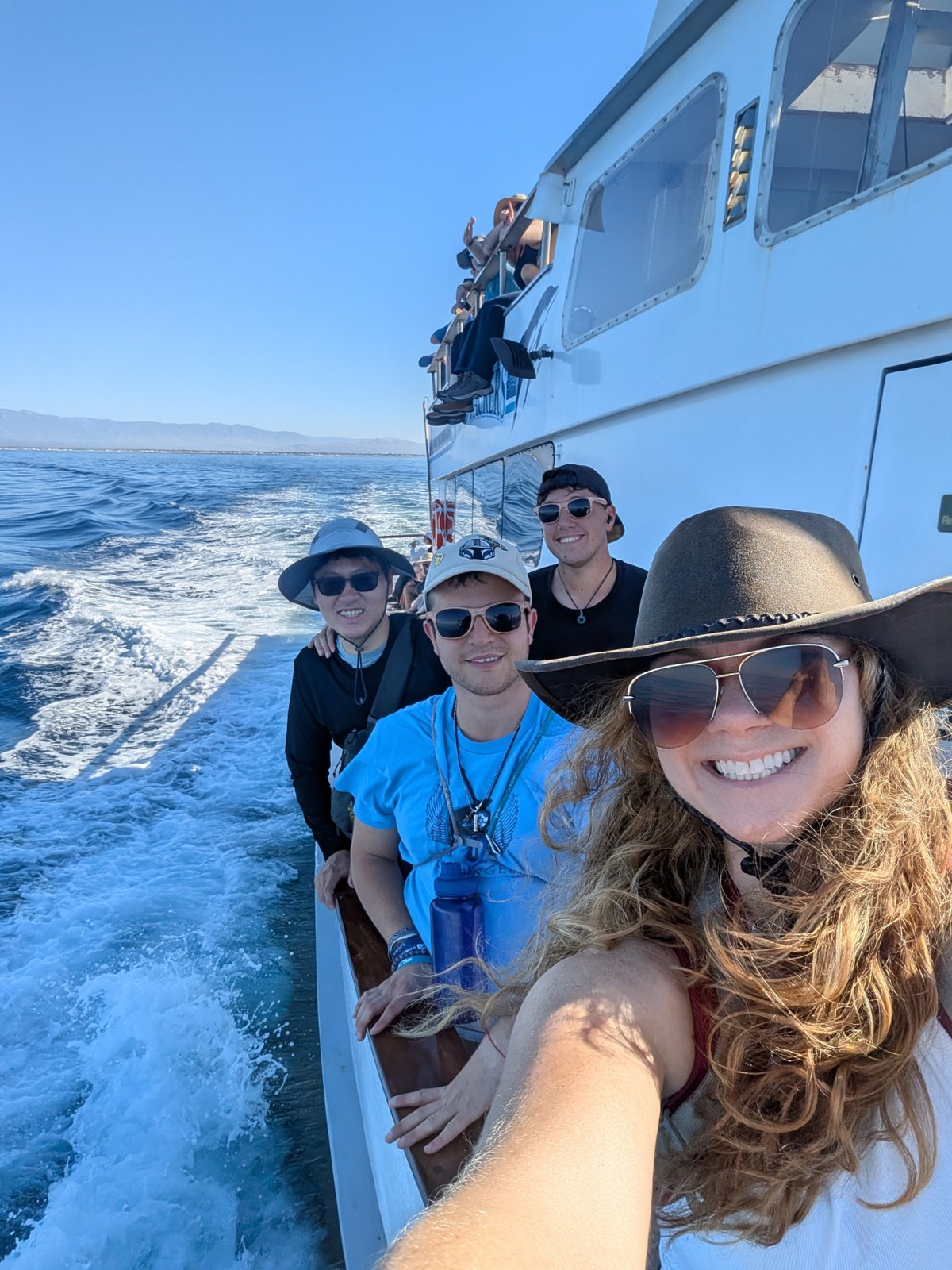 Participants smiling together on the boat to Channel Islands